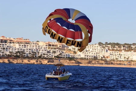 Sharm El Sheikh, Egypt - February 3 2018: Tourists are extremely entertained flying parasailing.のeditorial素材
