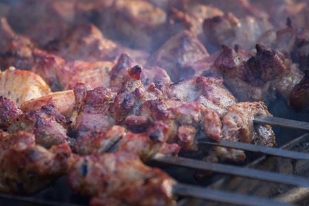 Marinated shashlik preparing on a barbecue grill over charcoal. Shashlik or Shish kebab popular in Eastern Europe.の写真素材