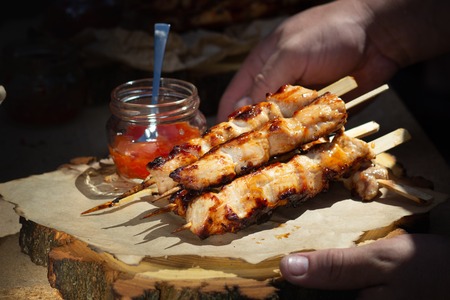 Thai food. Grilled meat balls. Pork balls put wood stick top with sauce on wood.の写真素材