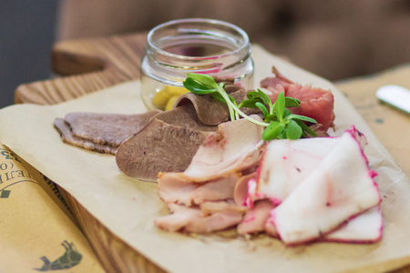 Raw meat steaks with spices on the black cutting boardの写真素材