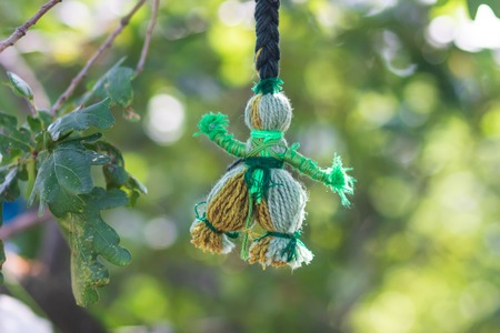Handmade Doll of Cotton Yarn. Folk doll. Motanka.a reel doll on a tree. pagan rite.