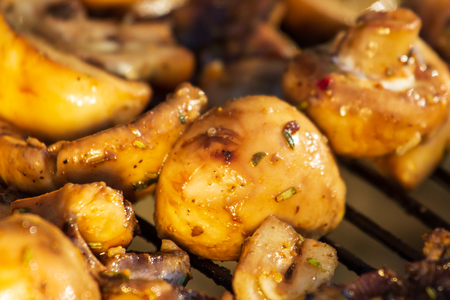 Cooking mushrooms on the grill in the restaurant.の写真素材