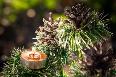 decorative Christmas tree with candle and cones.の写真素材