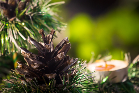 decorative Christmas tree with candle and cones.の写真素材