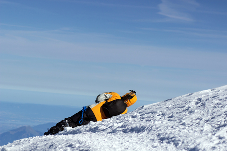 Climber fell and lies in the snow. Is sick mountaineerの写真素材