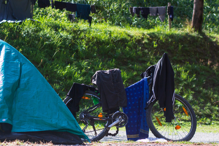 bike with things are dried in the sun on the campsite, the theme of rest and recreation.の写真素材