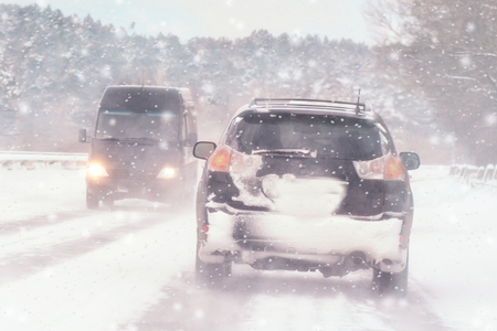 Winter, snow, Blizzard, poor visibility on the road. Car during a Blizzard on the road with the headlightsの写真素材