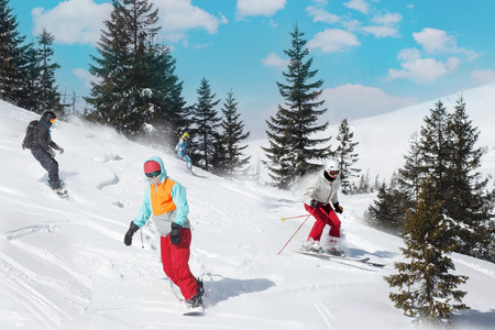 Group of happy friends snowboarders and skiers at ski resort. Winter vacationsの写真素材