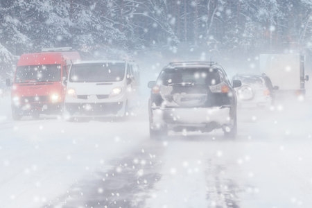 Winter, snow, Blizzard, poor visibility on the road. Car during a Blizzard on the road with the headlights.の写真素材