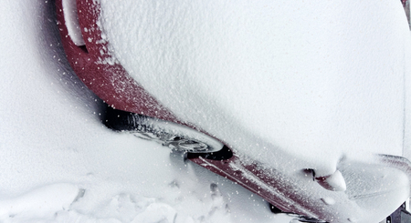 Winter tire. Car tire on snow road. Tires on snowy road detail.の写真素材