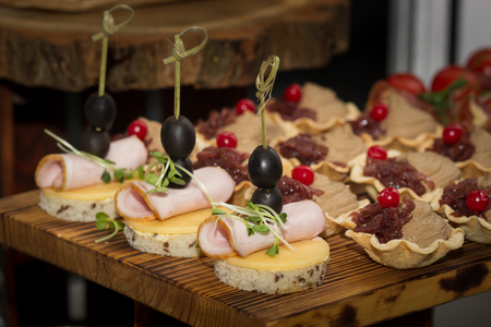 Beautifully decorated catering banquet table with different food snacks and appetizers with sandwich.の写真素材
