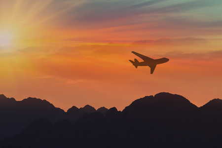 travel concept background, airplane in sunset sky, international flightの写真素材