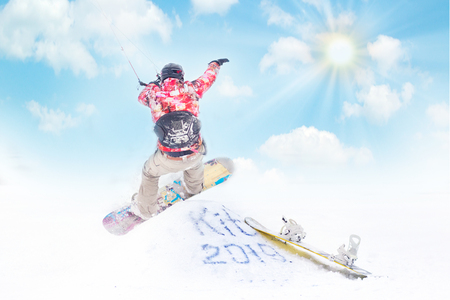 Man making hand stand on snowdrift winter snowkiting on a frozen lakeの写真素材
