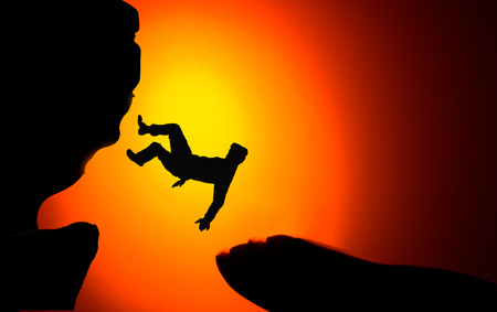 Man falling from the mountain edge. Conceptual scene.の写真素材