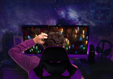 Gamer or streamer in earphones with microphone sits at home in dark room and plays with friends on...