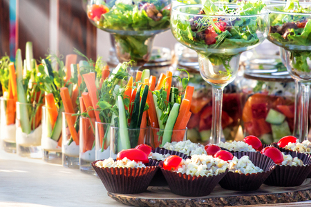 Beautifully decorated catering banquet table with different food snacks and appetizers with sandwichの写真素材
