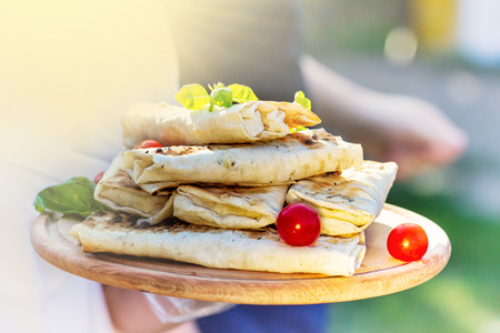 lavash or pita bread. two falafel on the wooden plate. Arabian dish fried balls of chickpeas or...