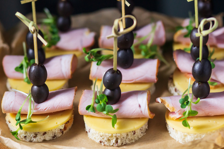 Beautifully decorated catering banquet table with different food snacks and appetizers with sandwich.の写真素材