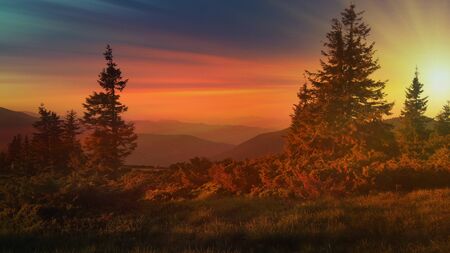 Autumn landscape with mountain, valley and lagoon views. The slopes of the hill are covered with scarlet arctous. Amazing sunsetの写真素材