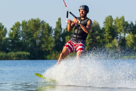 Cherkassy, Ukraine - July 19, 2019: Wakeboarder showing of tricks and skills at wakeboarding reverse event in Cherkassyのeditorial素材