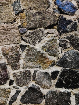 Background of stone wall texture. Old rock blocks