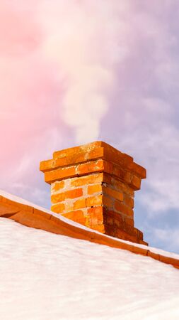 Old brick chimney on the roof. Brick masonry. Damaged chimney.の写真素材