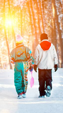 Little boys enjoy a sleigh ride. Child sledding. Toddler kid riding a sledge. Children play outdoors in snow. Kids sled in Alps mountains in winter. Outdoor fun for family Christmas vacation.の写真素材