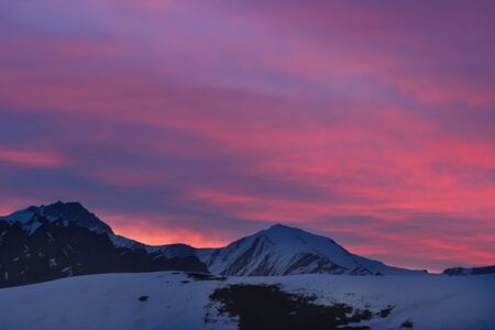 Red sunset in the mountains landscape with sunny beams. Dramatic scene. Carpathian, Ukraine, Europe. Beauty world. Retro style, vintage filter.の写真素材