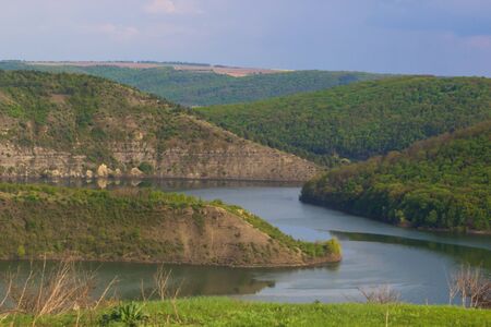 Beautiful natural scenery of river in southeast Asia tropical green forest with mountains in background, aerial viewの写真素材