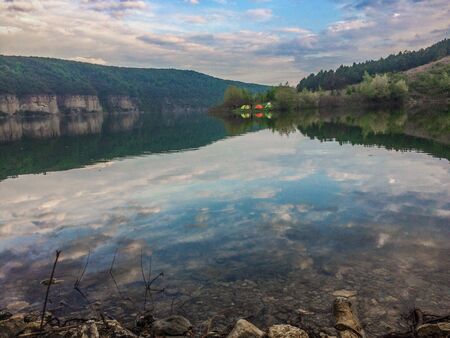Panoramic view from the hill on bend of the river. Beautiful summer landscape. Colorful clouds of the morning sky. Dniester Canyon located at the territory of Dniester River Valley in Ukraine.の写真素材