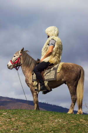 National clothes of Georgian shepherds burka and hat against mountains. Georgiaの写真素材
