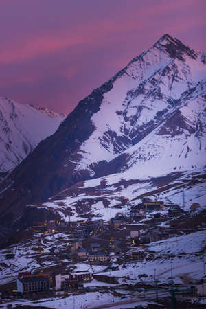 Sunset mountain peaks sky panorama. Mountain peaks sunset view. Sunset mountain peaks silhouette. Mountain sunset sky cloudsの写真素材
