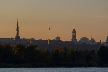 Beautiful a view of Pechersk Lavra in Kyiv at sunrise. A UNESCO world heritage site in Ukraine. View from river Dniepr. Space for text.の写真素材