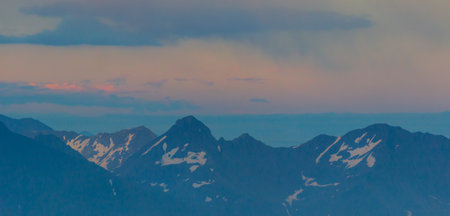 Mountain range with visible silhouettes through the morning colorful fog. Sunriseの写真素材