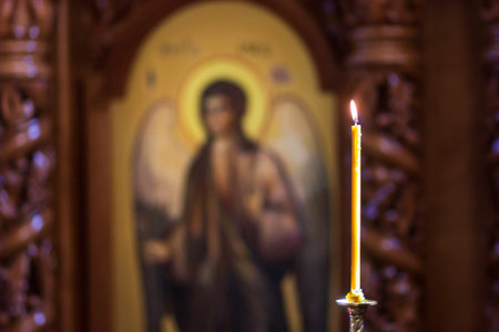 Beautiful a single candle light in the dark church, idea of to respect someone you love, to remember and make a wish come true, for backgroundの写真素材