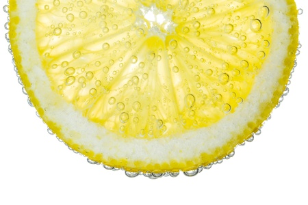 Lemon Slice in Clear Fizzy Water Bubble Background Isolatedの写真素材