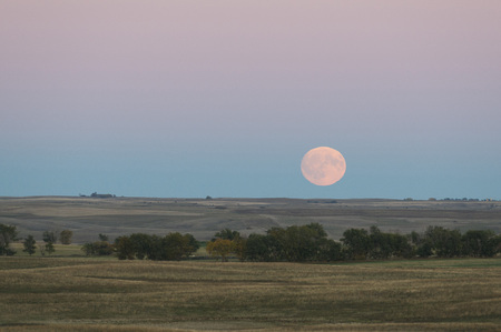A full moon rising over the North Dakota Prairieの写真素材