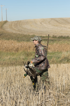 A young duck hunter with Mallard ducks in North Dakotaの写真素材