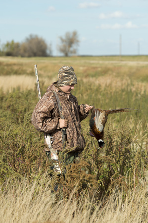 A young Pheasant Hunter in South Dakotaの写真素材