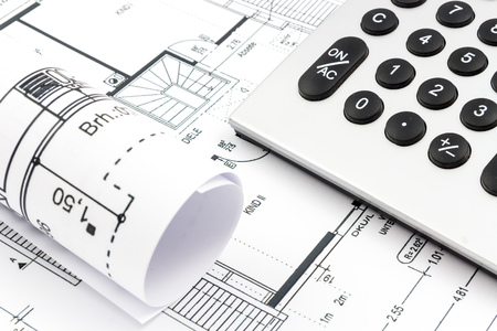 Architectural drawings of a house with calculatorの写真素材