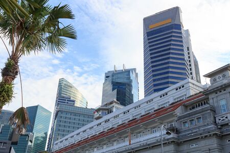 Fullerton Building and Singapore skyline near Marina bay with palm treeのeditorial素材