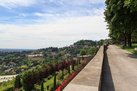 View from park in Citta Alta to hill San Vigilio panorama in Bergamo, Italyの写真素材