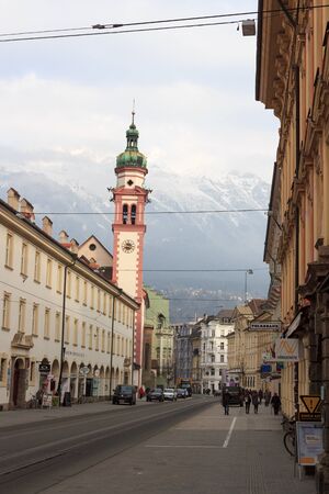 Innsbruck cityscape with church spire and snow mountains, Austriaのeditorial素材