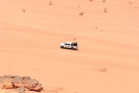 Tourists sitting in pickup truck and enjoying a guided tour in Wadi Rum desert, Jordanのeditorial素材
