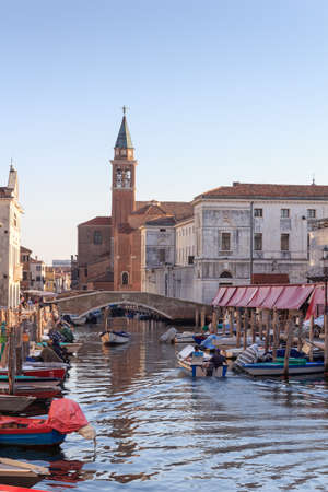 View of town Chioggia with canal Vena and church steeple of Chiesa della Santissima Trinita in Veneto, Italyの写真素材