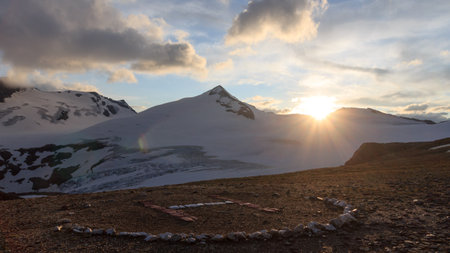 Mountain snow panorama, summit Johannisberg (High Tauern) and helicopter landing site during sunset in Glockner Group, Austriaの写真素材