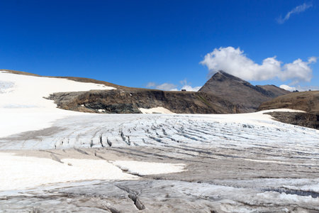 Mountain panorama, alpine hut Oberwalderhuette and glacier Pasterze with icefall Hufeisenbruch and crevasses in Glockner Group, Austriaの写真素材