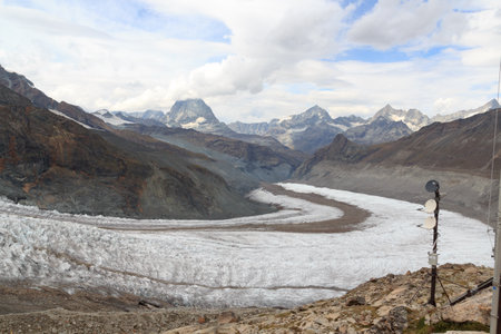 Panoramic view with mountain Matterhorn in the clouds and Gorner Glacier in Pennine Alps, Switzerlandの写真素材