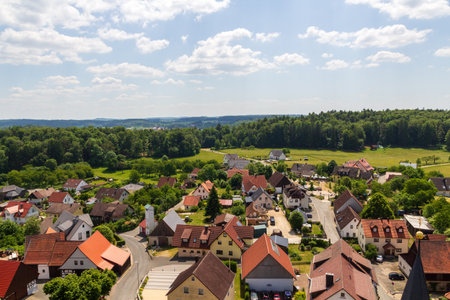 Rural scene with hill panorama, meadows and houses of village Wichsenstein in Franconian...
