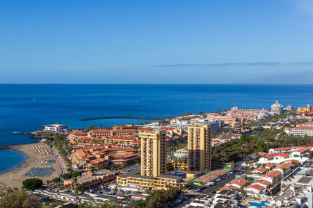 Panorama of hotels and Atlantic Ocean holiday resort Playa de las Americas on Canary Island...